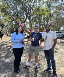 Two staff posing outdoors